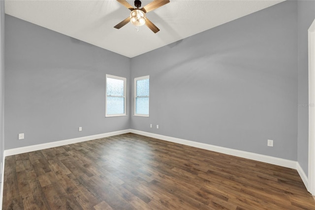 spare room featuring ceiling fan and dark hardwood / wood-style flooring