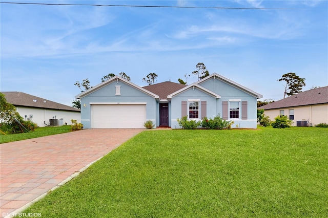 view of front facade with central AC unit, a garage, and a front yard