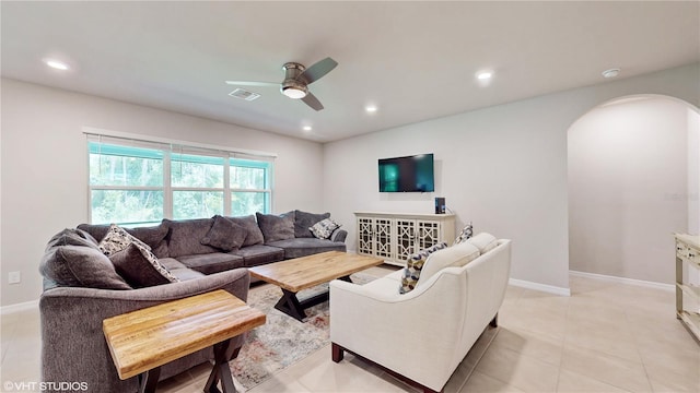 tiled living room featuring ceiling fan