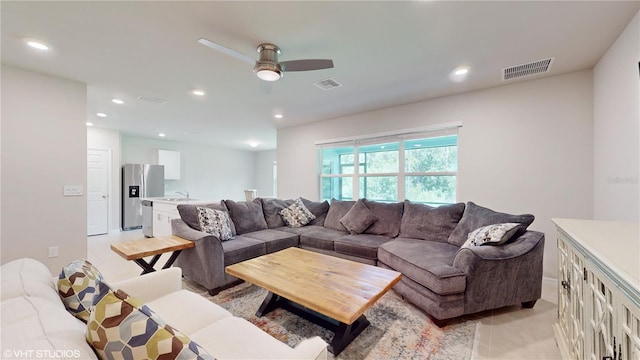 living room with ceiling fan and sink