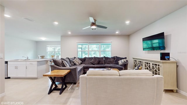 living room featuring ceiling fan and sink