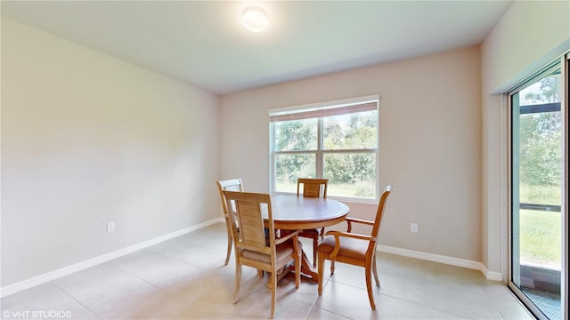 dining area with a wealth of natural light and light tile patterned flooring