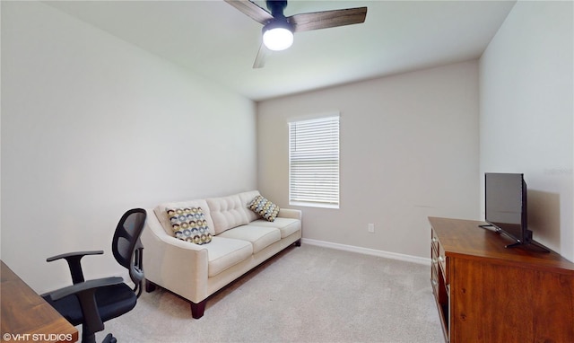 carpeted office space featuring ceiling fan