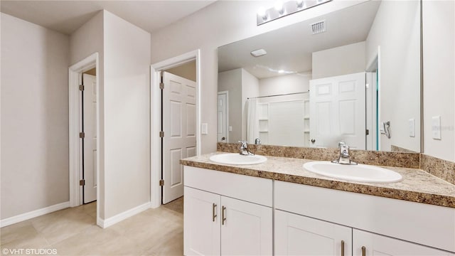 bathroom featuring vanity, an enclosed shower, and tile patterned flooring