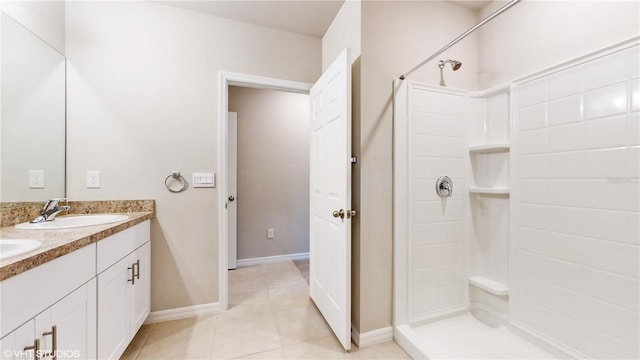 bathroom featuring a shower, vanity, and tile patterned floors