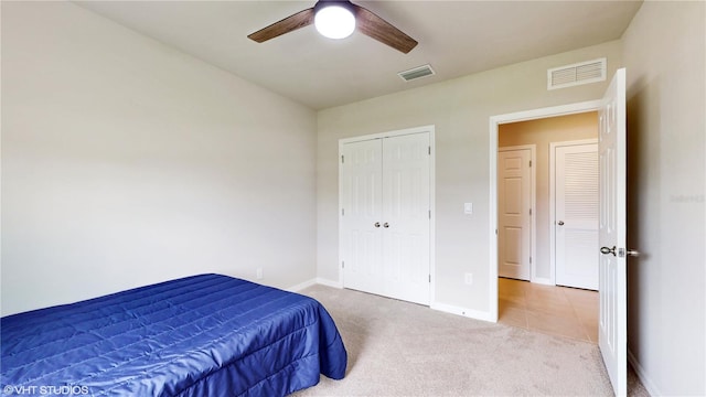 carpeted bedroom with a closet and ceiling fan