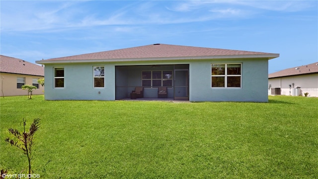 rear view of house featuring a yard