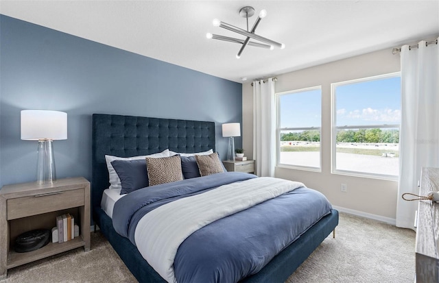 bedroom with a chandelier and light carpet