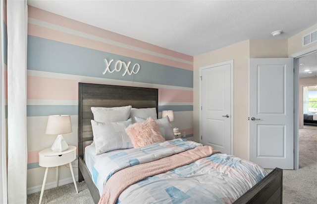 bedroom featuring a textured ceiling and carpet flooring