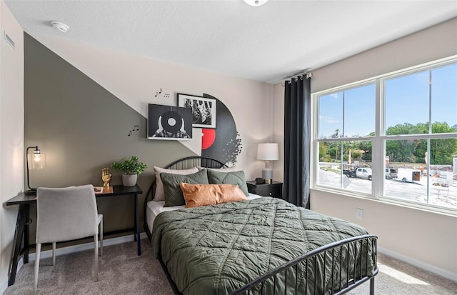 carpeted bedroom featuring a textured ceiling