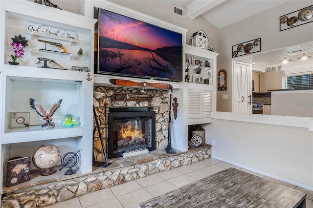 unfurnished living room featuring a fireplace, tile patterned flooring, and vaulted ceiling with beams