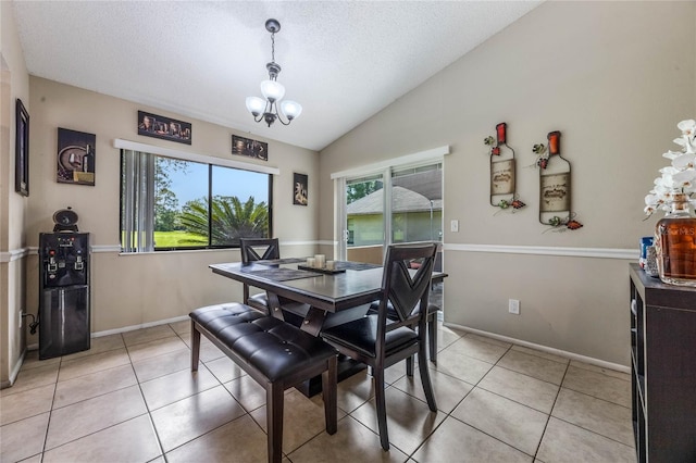 tiled dining area featuring lofted ceiling, a notable chandelier, and a textured ceiling