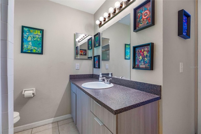 bathroom with vanity, toilet, and tile patterned floors