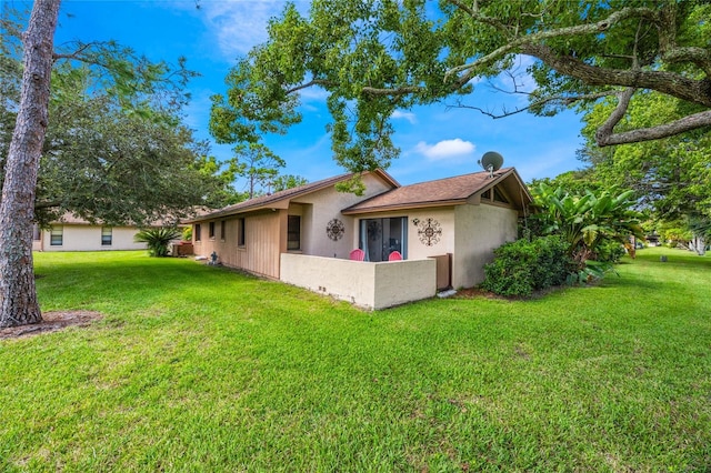 view of property exterior with a yard