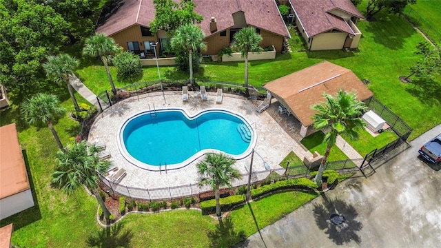 view of pool with a lawn, a shed, and a patio area