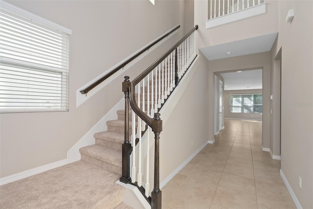 stairway with tile patterned flooring