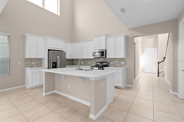 kitchen with light tile patterned floors, light countertops, visible vents, appliances with stainless steel finishes, and a sink