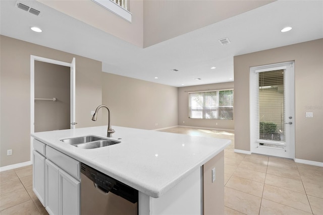 kitchen with visible vents, a sink, stainless steel dishwasher, and light tile patterned flooring