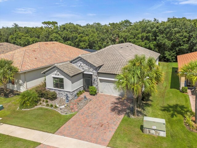 view of front of home with a front lawn and a garage