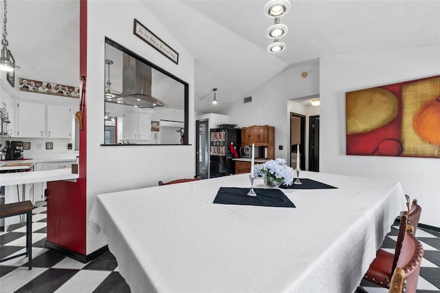 dining space with vaulted ceiling