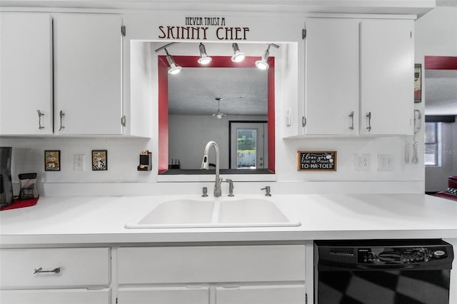 kitchen featuring dishwasher and white cabinetry