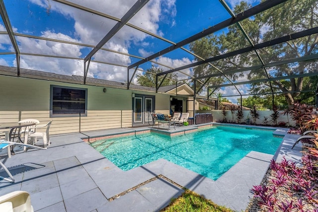 view of swimming pool featuring a lanai and a patio area