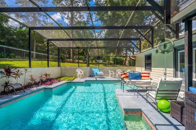 view of pool featuring glass enclosure and a patio area