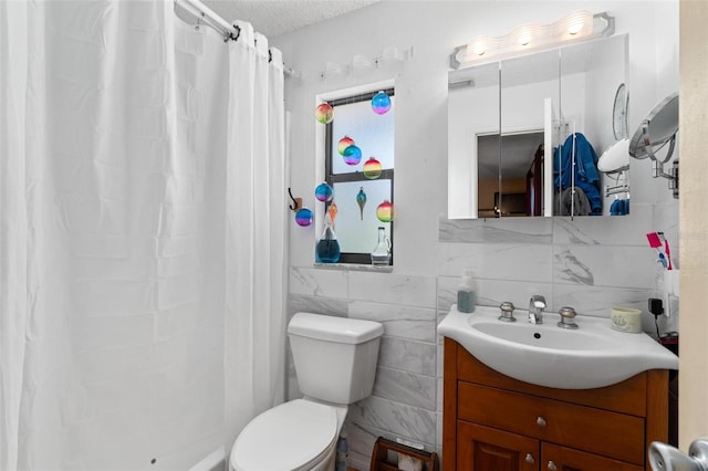 bathroom featuring walk in shower, toilet, tile walls, vanity, and a textured ceiling