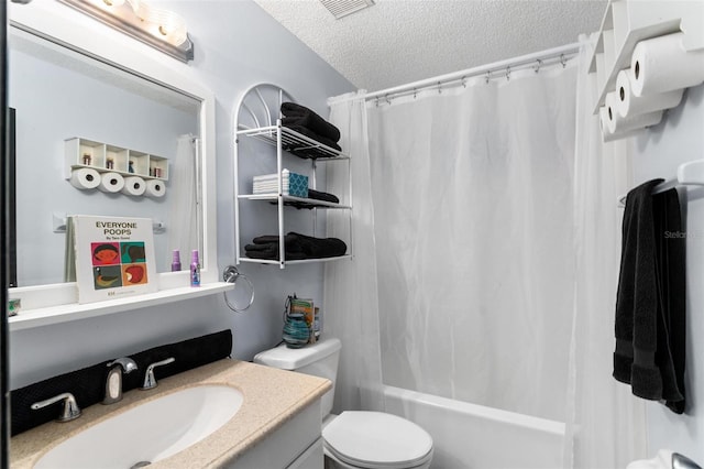 full bathroom featuring vanity, shower / bath combo with shower curtain, toilet, and a textured ceiling