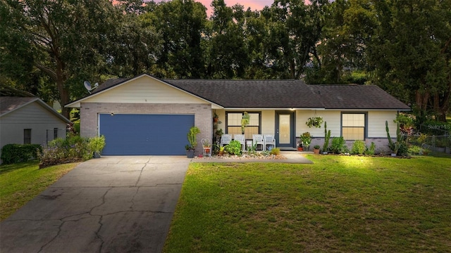 ranch-style home featuring a porch, a lawn, and a garage