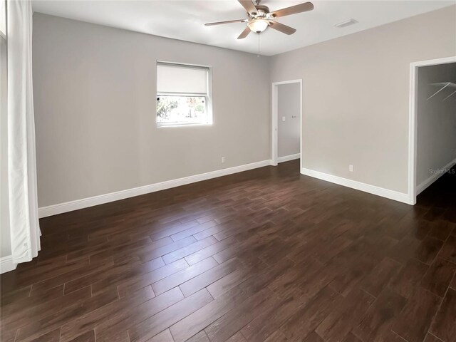 spare room with dark wood-type flooring and ceiling fan