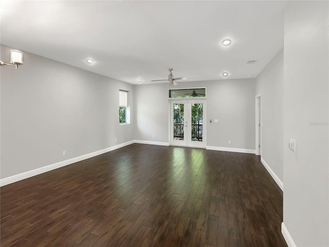 unfurnished room with ceiling fan, dark hardwood / wood-style floors, and french doors