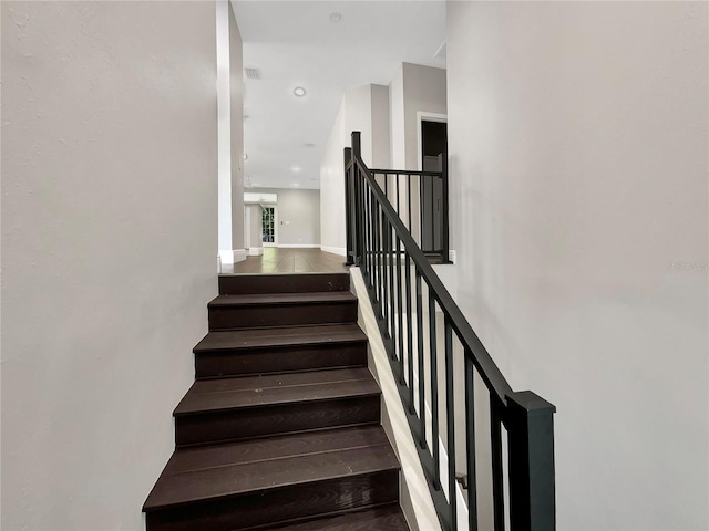 staircase with hardwood / wood-style flooring