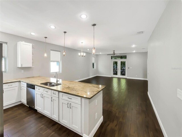 kitchen with plenty of natural light, kitchen peninsula, and dark hardwood / wood-style floors