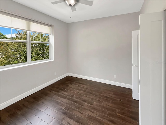 spare room with ceiling fan and dark hardwood / wood-style flooring