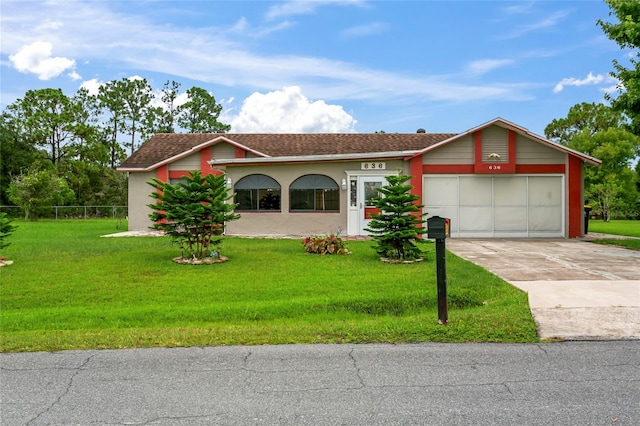 single story home featuring a garage and a front yard