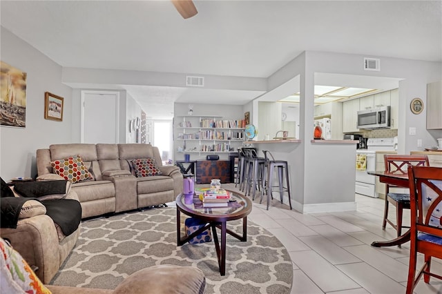 tiled living room with ceiling fan