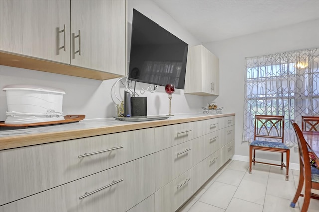 kitchen featuring light brown cabinets and light tile patterned flooring