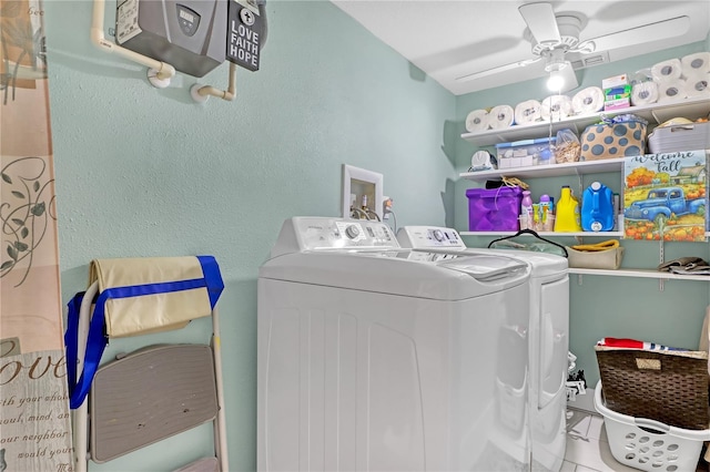 clothes washing area featuring washing machine and dryer, ceiling fan, and tile patterned floors