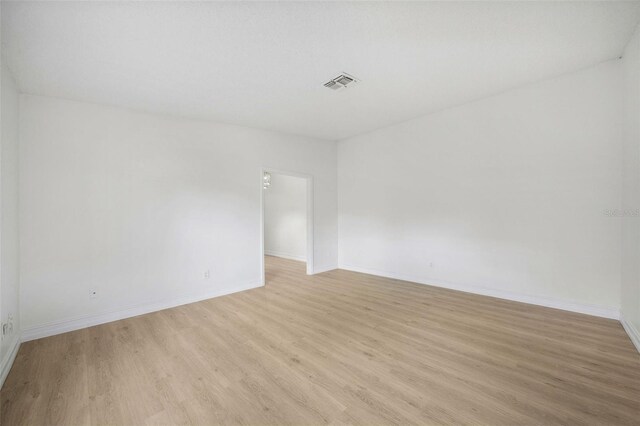 unfurnished room with light wood-type flooring