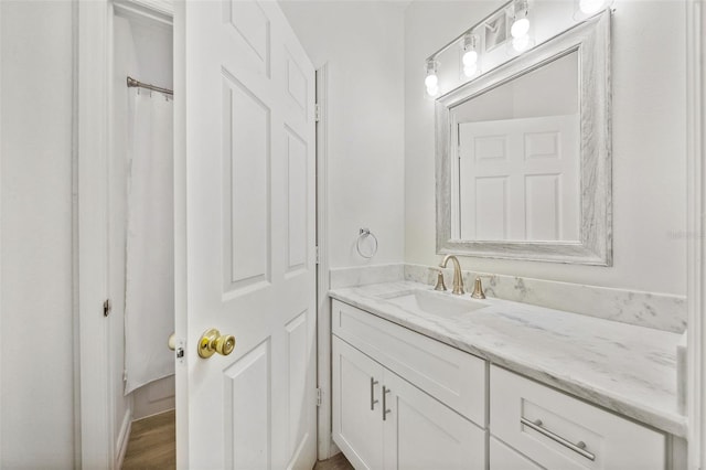 bathroom with vanity and hardwood / wood-style flooring