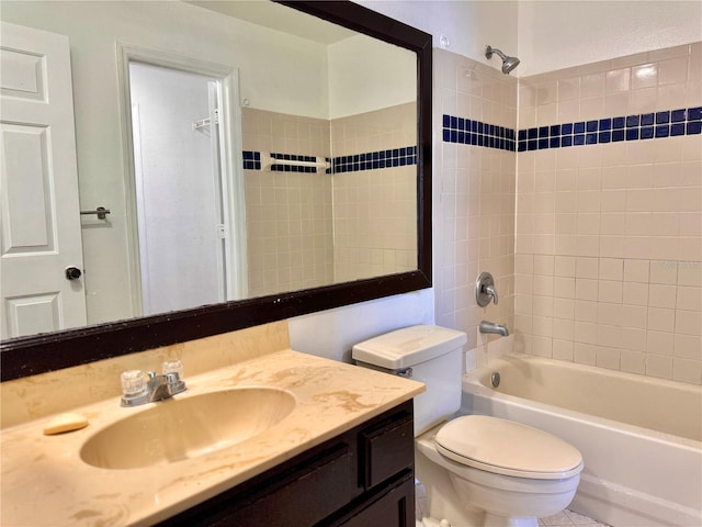 full bathroom with tile patterned flooring, tiled shower / bath, toilet, and vanity