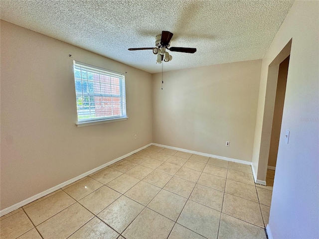 tiled empty room with a textured ceiling and ceiling fan