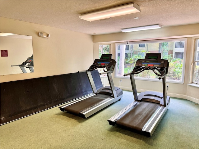 workout room with a textured ceiling and carpet