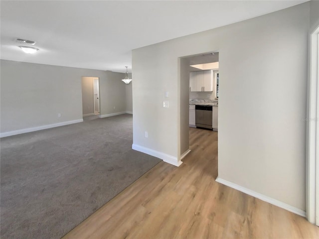 empty room with light hardwood / wood-style flooring