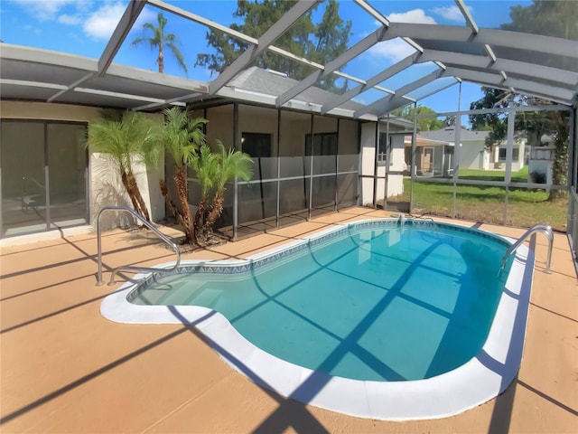 view of swimming pool featuring a lanai and a patio