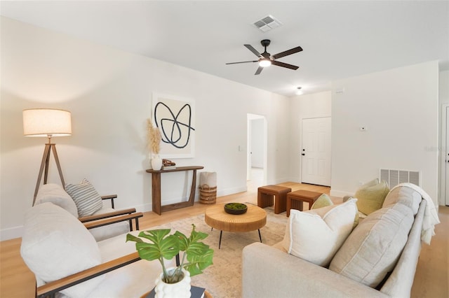 living room with light hardwood / wood-style floors and ceiling fan