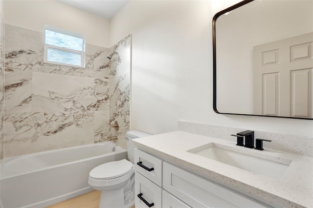 full bathroom with toilet, tiled shower / bath combo, vanity, and hardwood / wood-style flooring