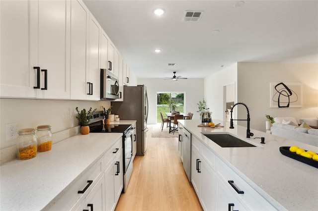 kitchen featuring white cabinetry, appliances with stainless steel finishes, and sink