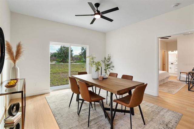 dining space with light hardwood / wood-style floors and ceiling fan